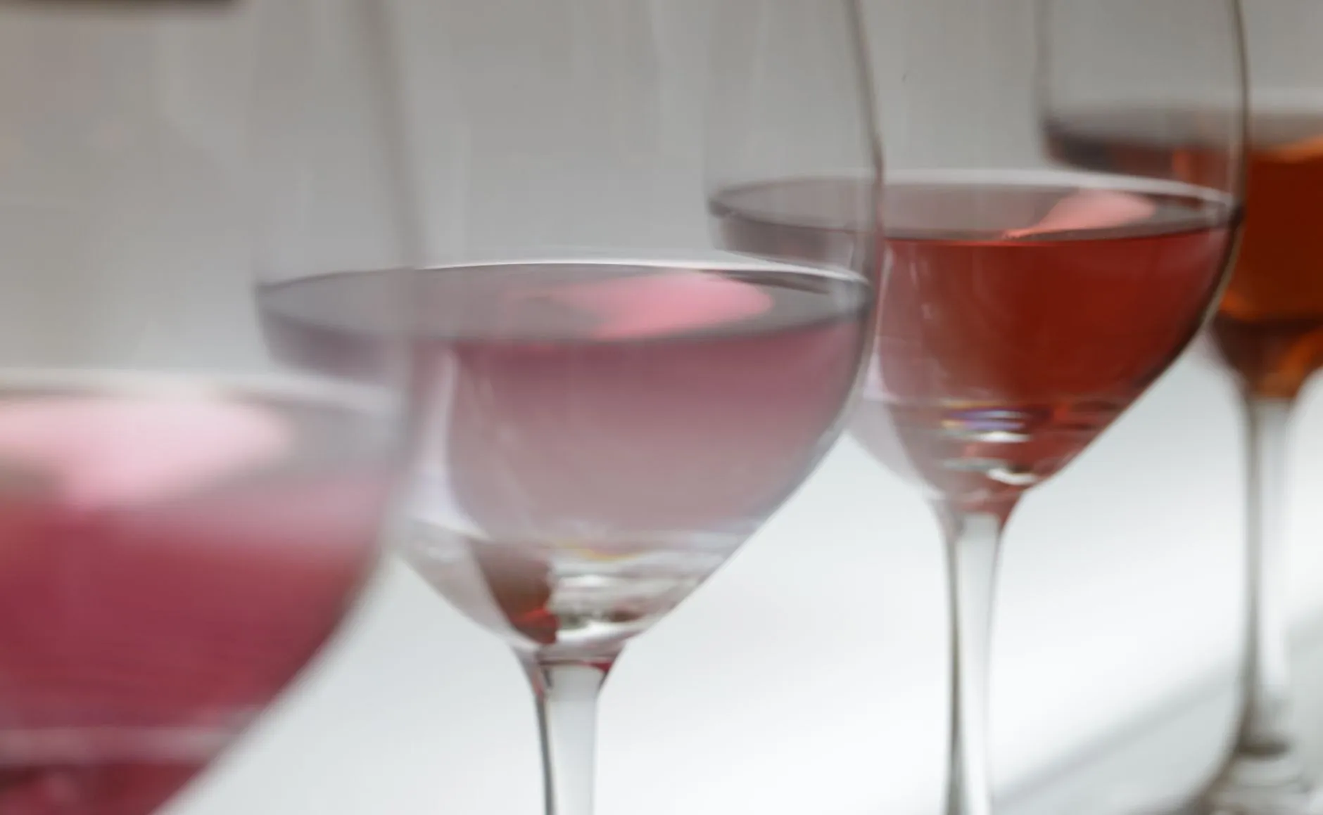 Glasses of pale pink sparkling rosé in soft light